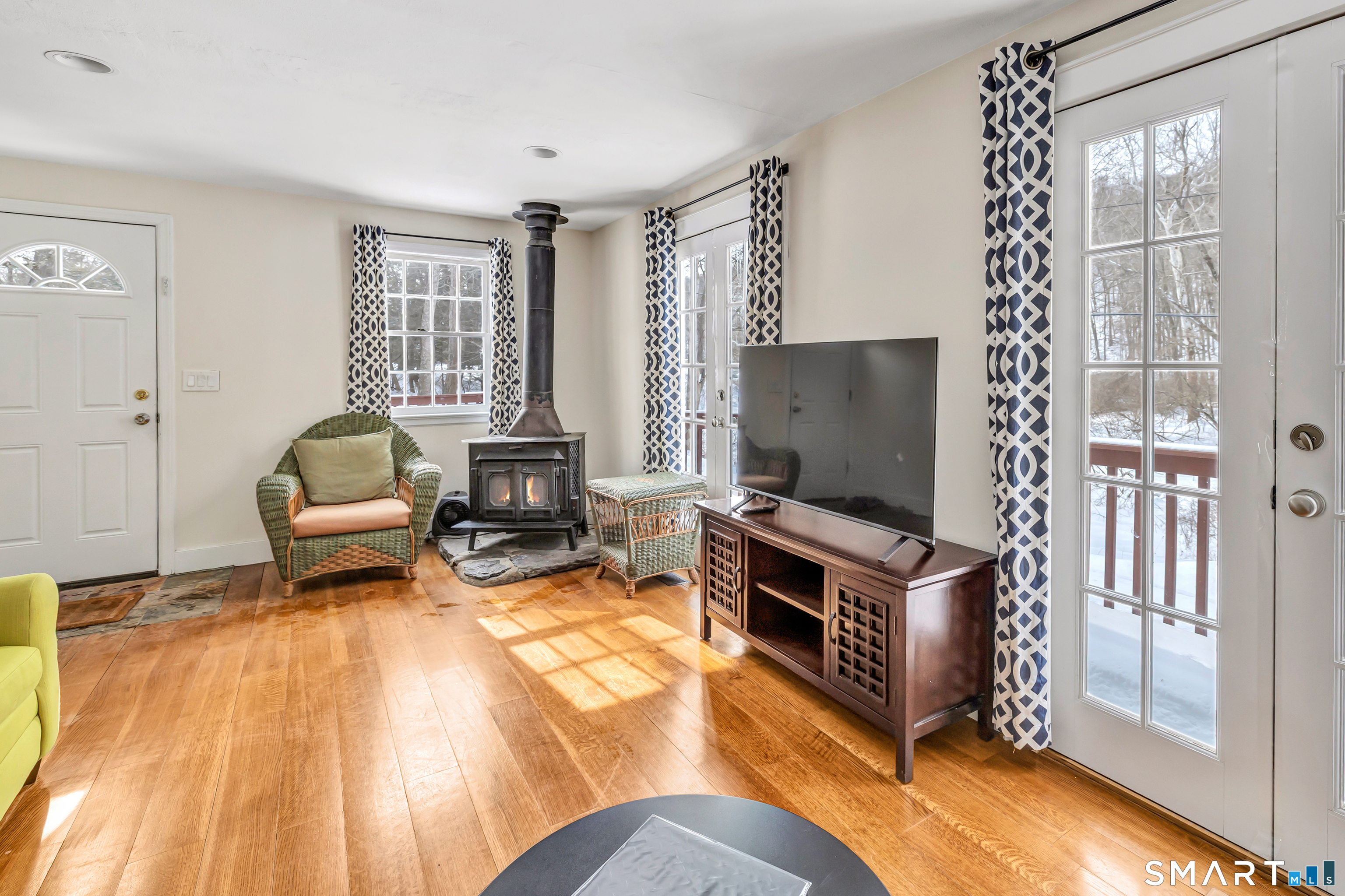 274 Lyons Plain Road Weston, CT 06883 - Photo 24 of 40 a living room with furniture window and flat screen tv