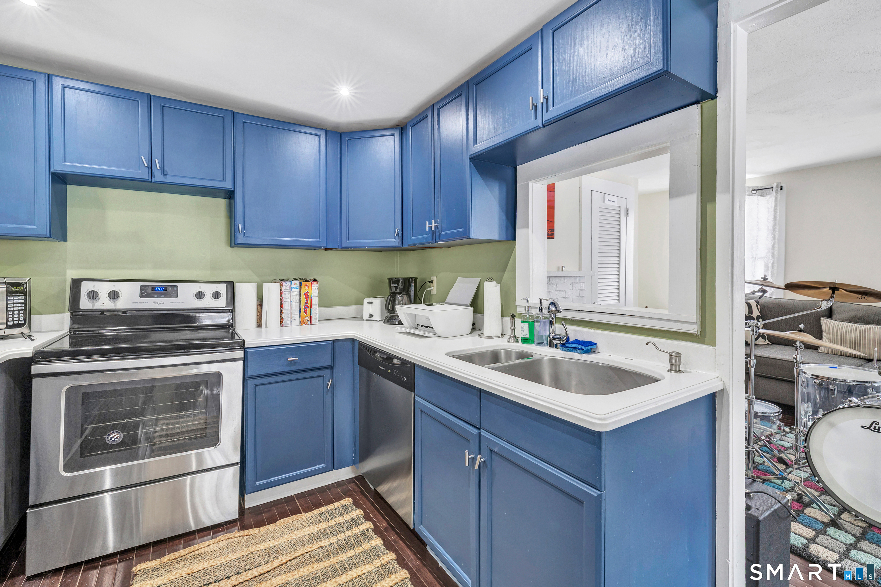 274 Lyons Plain Road Weston, CT 06883 - Photo 28 of 40 a kitchen with a sink stove and cabinets
