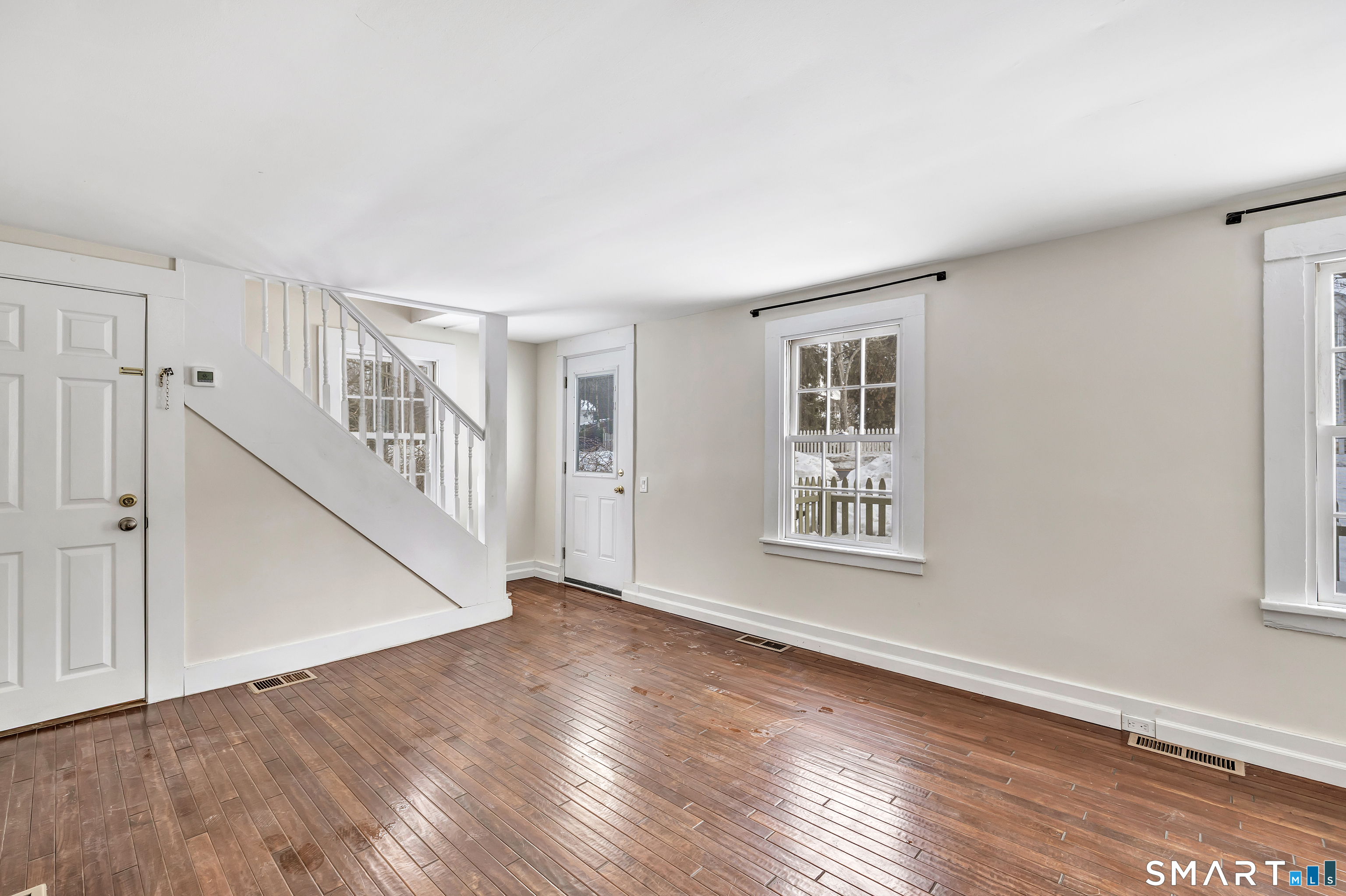 274 Lyons Plain Road Weston, CT 06883 - Photo 3 of 40 a view of an empty room with wooden floor and a window