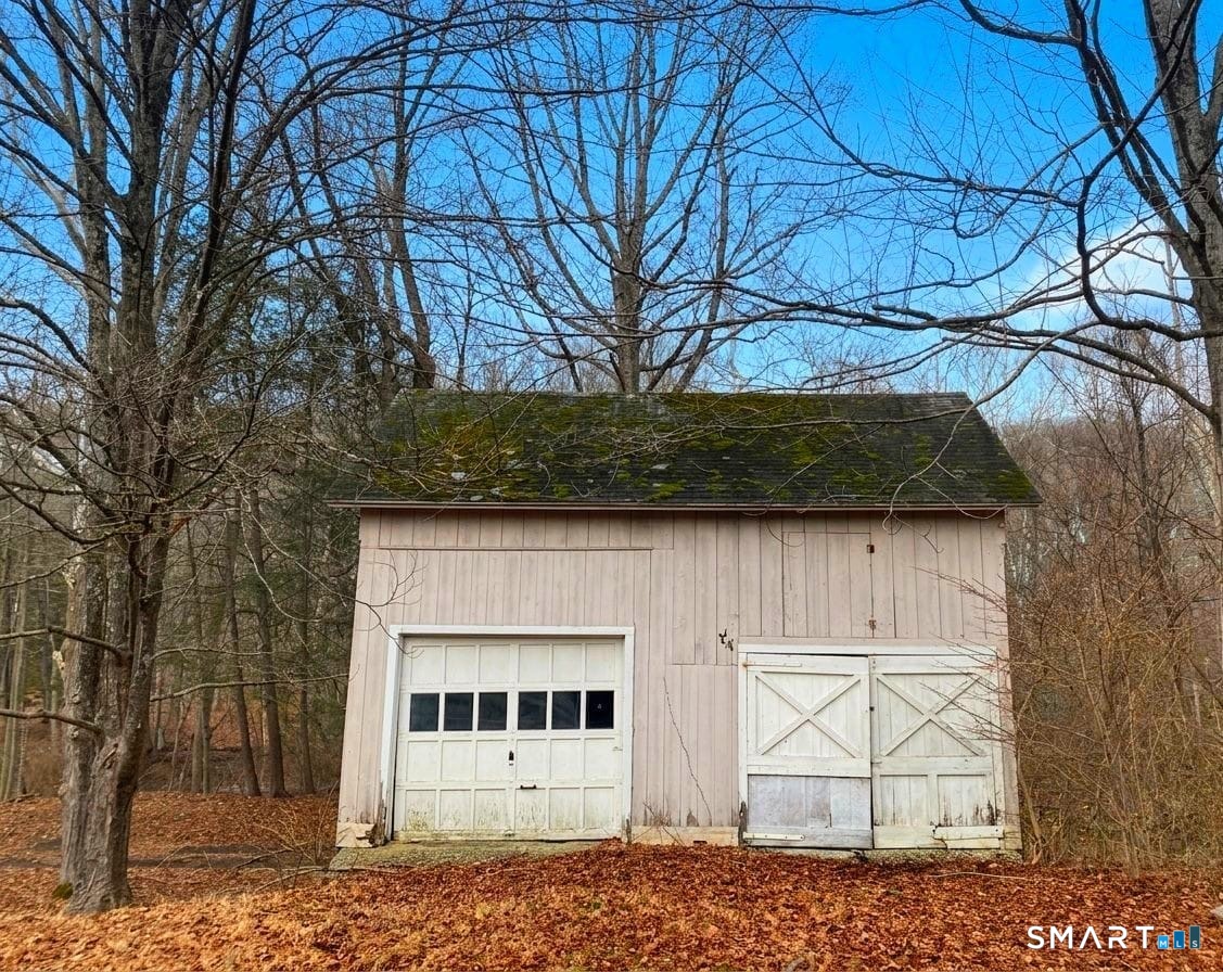 274 Lyons Plain Road Weston, CT 06883 - Photo 40 of 40 a view of a small house with a tree