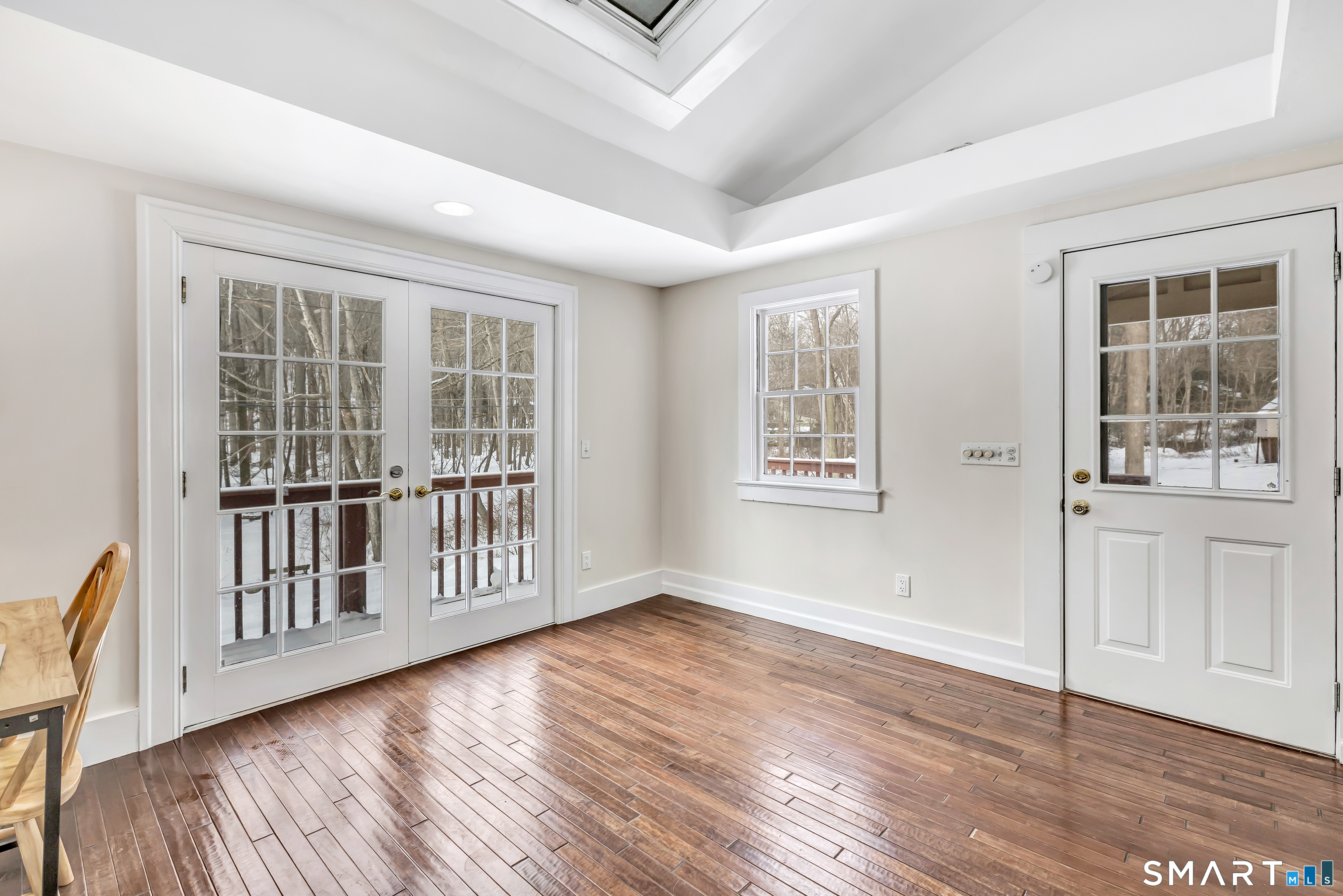 274 Lyons Plain Road Weston, CT 06883 - Photo 9 of 40 a view of an empty room with wooden floor and a window
