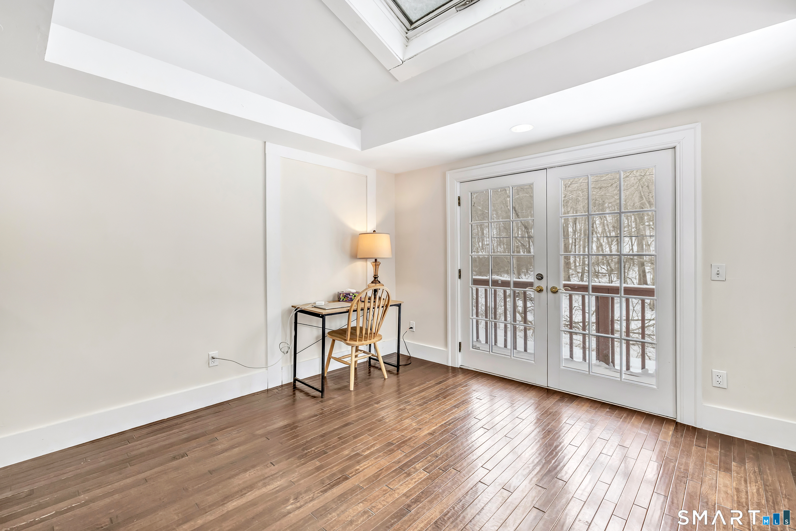 274 Lyons Plain Road Weston, CT 06883 - Photo 10 of 40 an empty room with wooden floor and windows