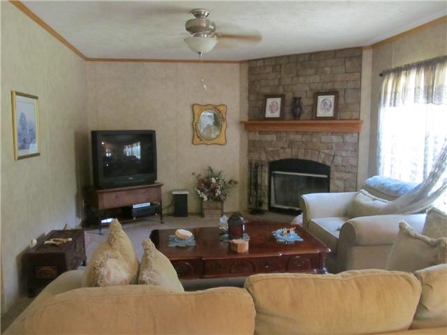1208 Hurricane Road Tullahoma, TN 37388 - Photo 3 of 13 Family room with woodburning fireplace to take chill of winter eve. Lots of firewood availablel.