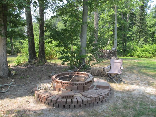 1208 Hurricane Road Tullahoma, TN 37388 - Photo 10 of 13 Enjoy sitting around the firepit with friends. Stack of wood ready for you to use in the fireplace.