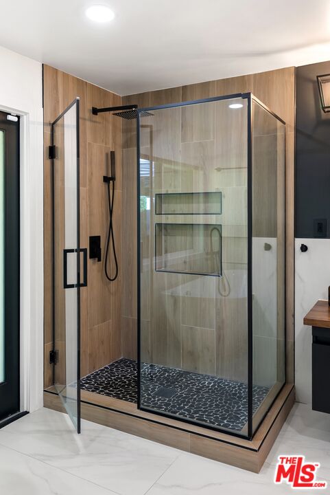 4118 Oak Hollow Road Calabasas, CA 91302 - Photo 40 of 55 a bathroom with a shower and a sink