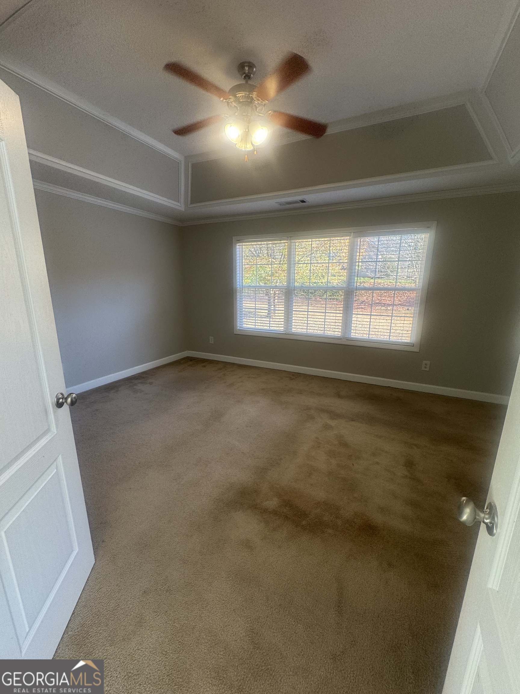 180 Laurel Oaks Lane Jefferson, GA 30549 - Photo 19 of 26 en empty room with windows and entrance