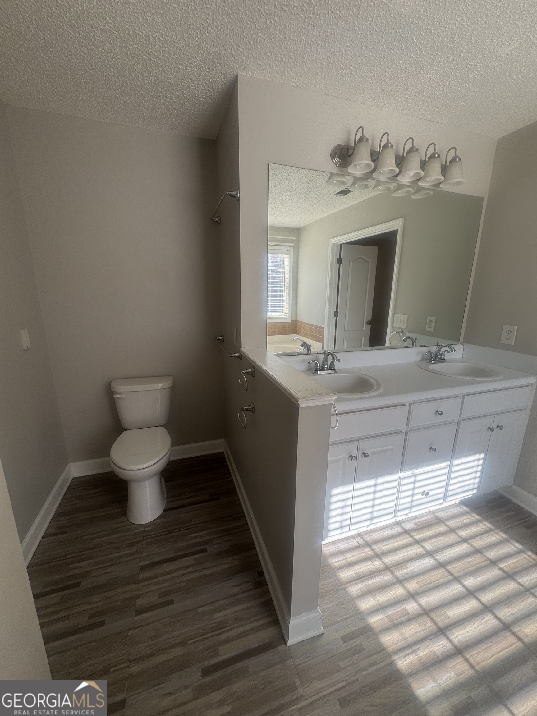 180 Laurel Oaks Lane Jefferson, GA 30549 - Photo 21 of 26 a bathroom with a sink toilet and mirror