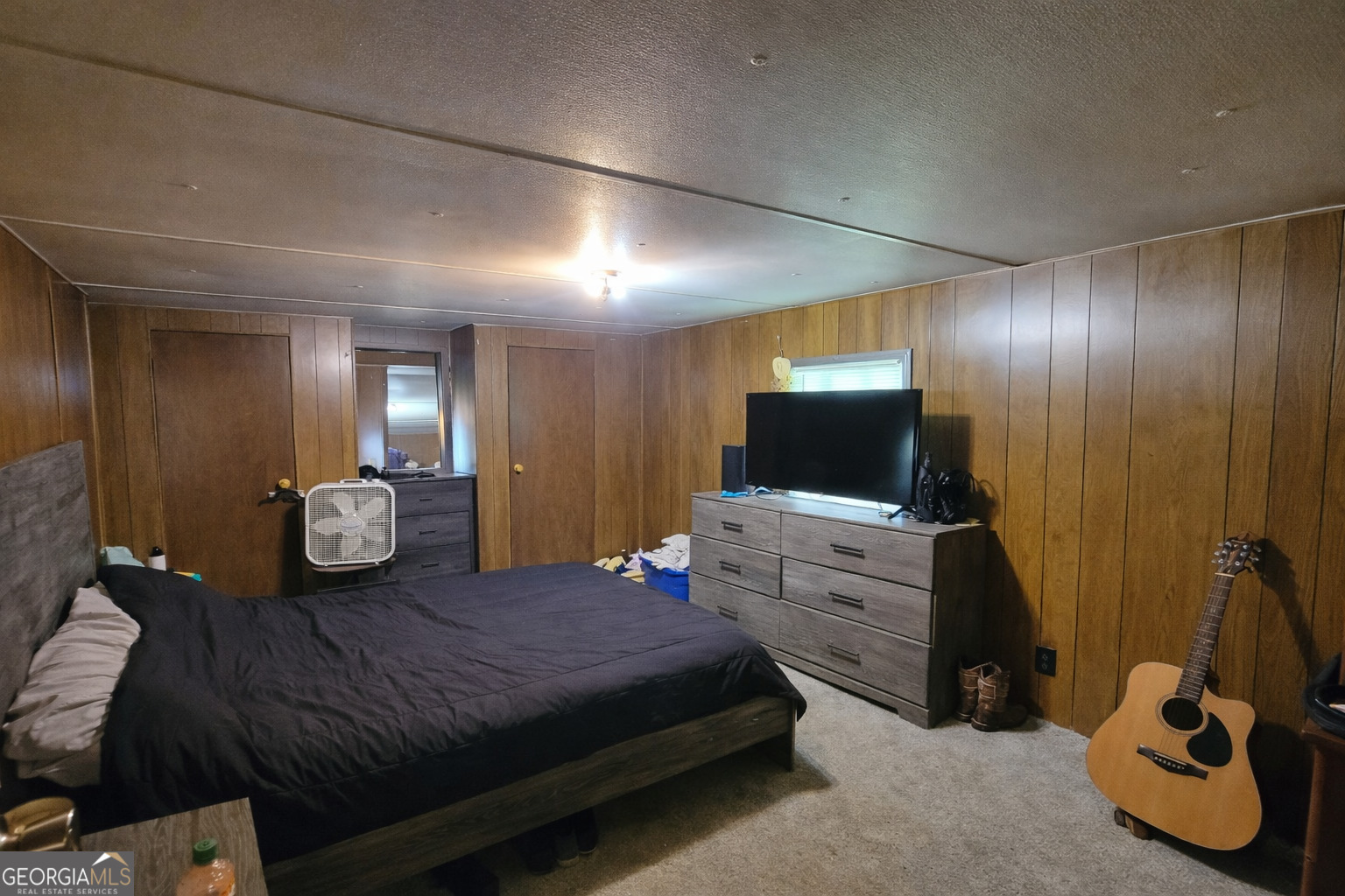 200 Homer Stephens Road Cornelia, GA 30531 - Photo 12 of 16 a spacious bedroom with a bed and a flat screen tv