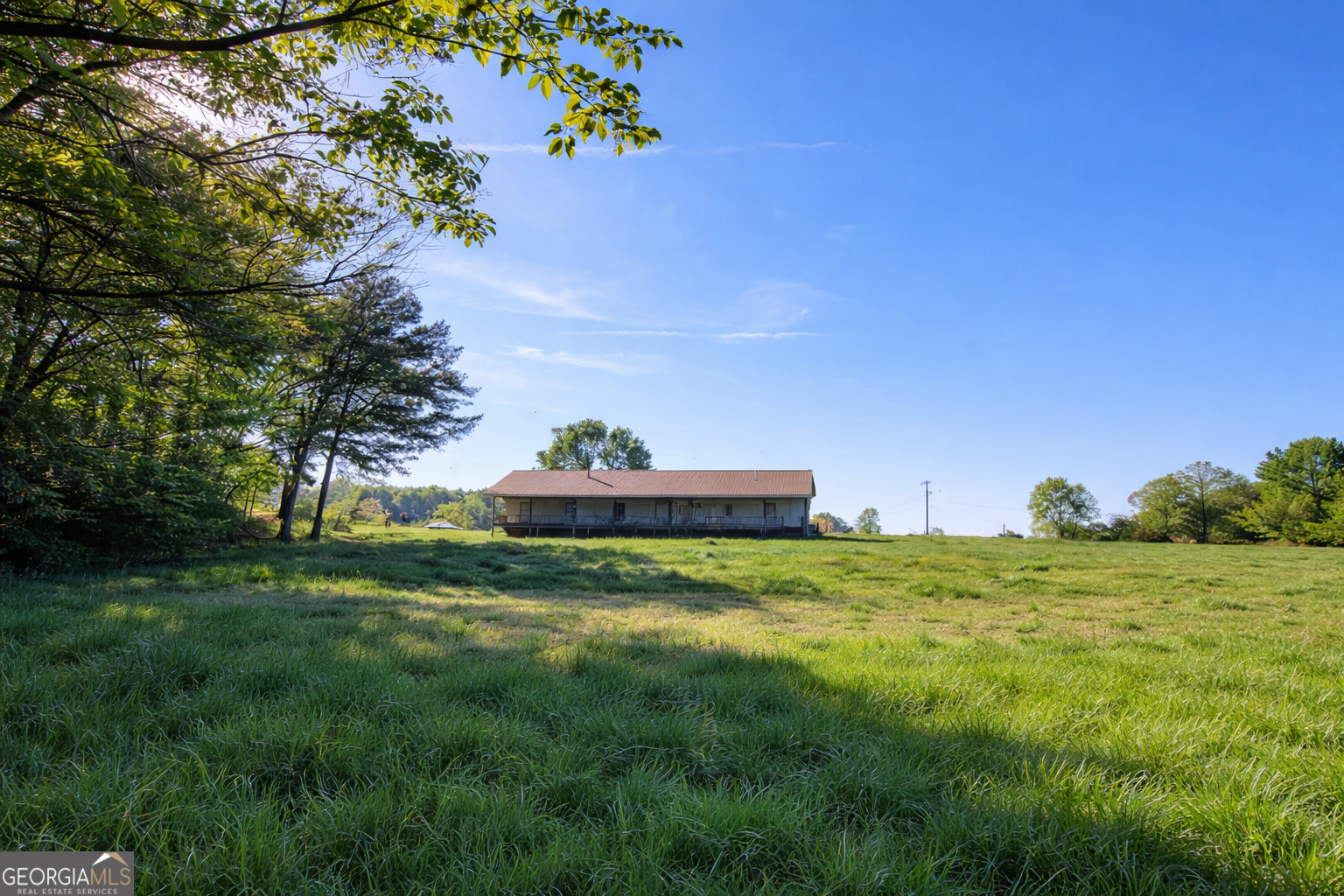 200 Homer Stephens Road Cornelia, GA 30531 - Photo 4 of 16 a backyard of a house with lots of green space and trampoline