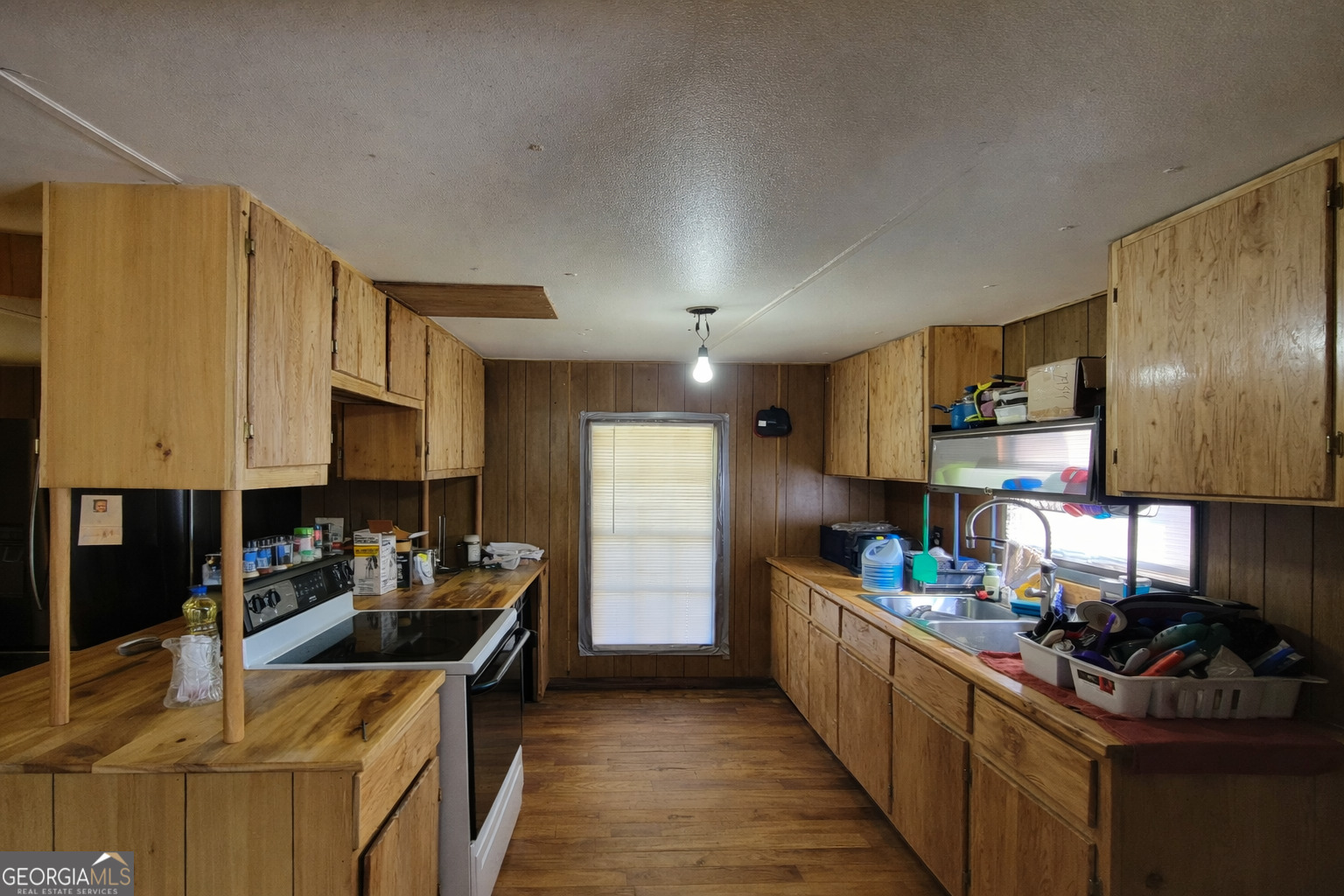 200 Homer Stephens Road Cornelia, GA 30531 - Photo 8 of 16 a kitchen with stainless steel appliances granite countertop a sink stove and refrigerator