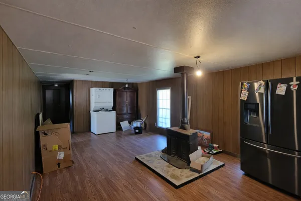 a living room with furniture hard wood floor and a table