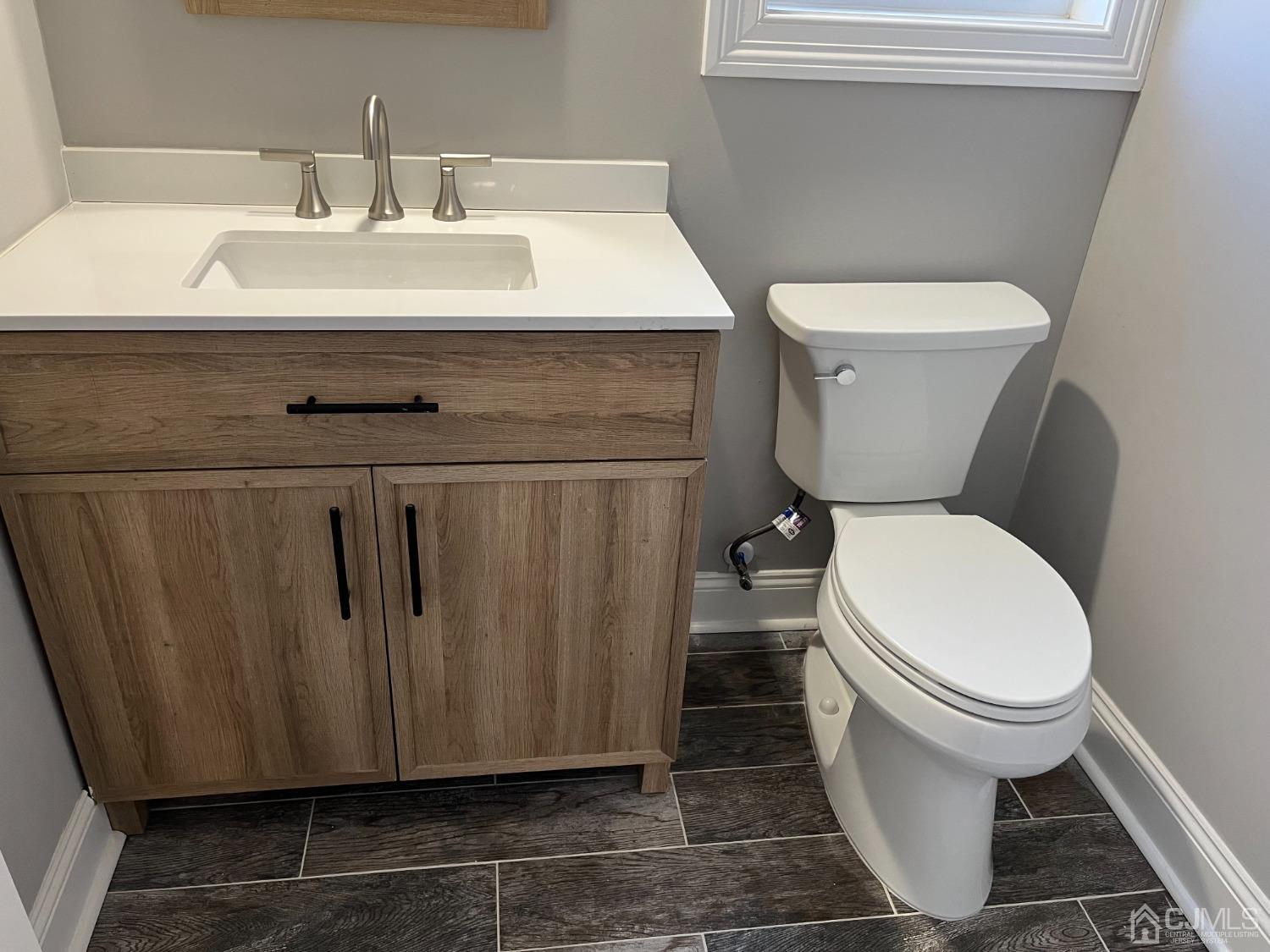 80 Kimberly Road Colonia, NJ 07067 - Photo 11 of 33 a bathroom with a toilet and a sink