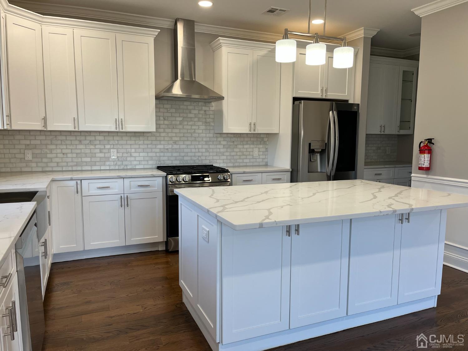 80 Kimberly Road Colonia, NJ 07067 - Photo 12 of 33 a kitchen with a sink a refrigerator and cabinets