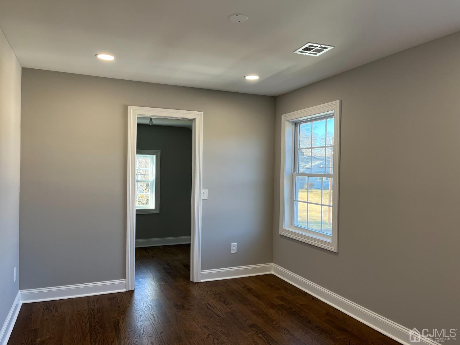 80 Kimberly Road Colonia, NJ 07067 - Photo 21 of 33 an empty room with wooden floor and windows
