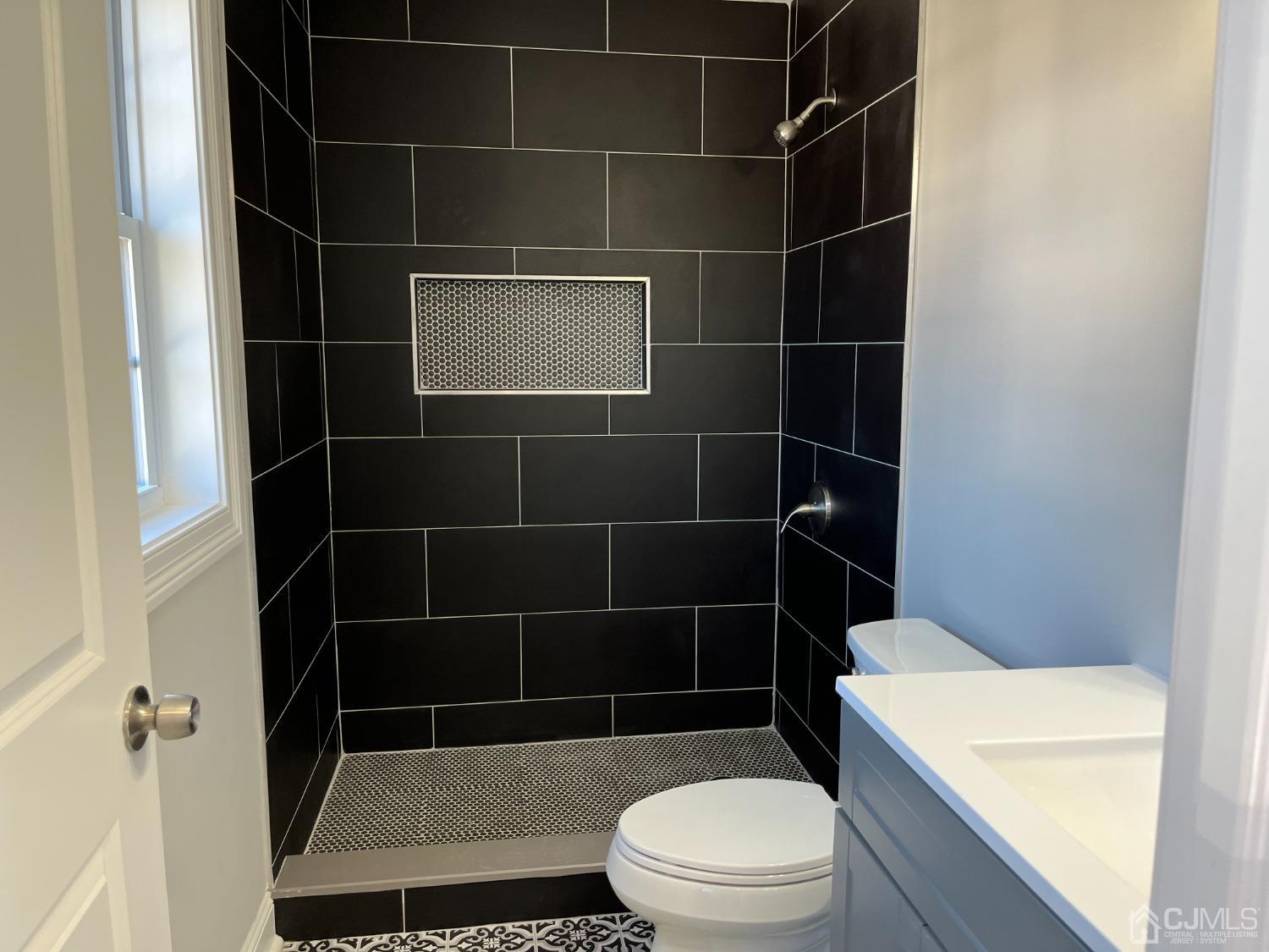 80 Kimberly Road Colonia, NJ 07067 - Photo 24 of 33 a bathroom with a toilet a sink a mirror and a shower