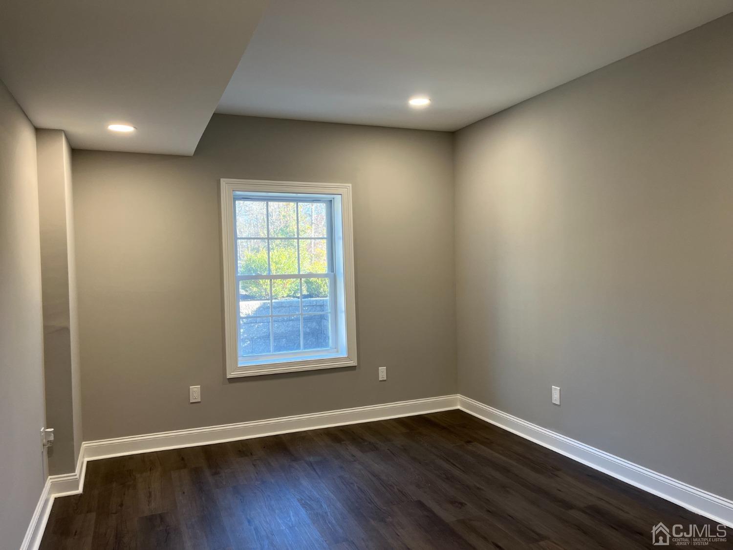 80 Kimberly Road Colonia, NJ 07067 - Photo 30 of 33 an empty room with wooden floor and windows