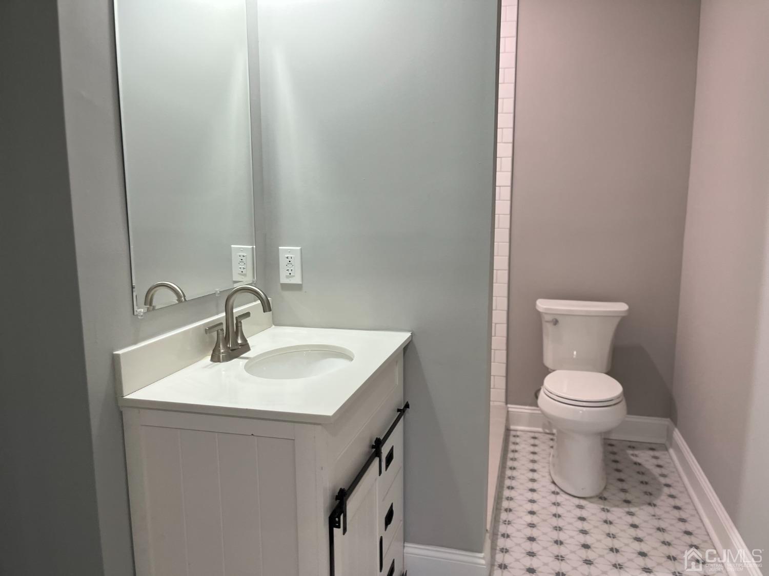80 Kimberly Road Colonia, NJ 07067 - Photo 33 of 33 a bathroom with a sink a toilet and a mirror