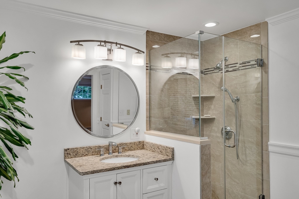 2270 Massachusetts Avenue Lexington, MA 02421 - Photo 18 of 34 a bathroom with a sink a mirror a vanity and shower