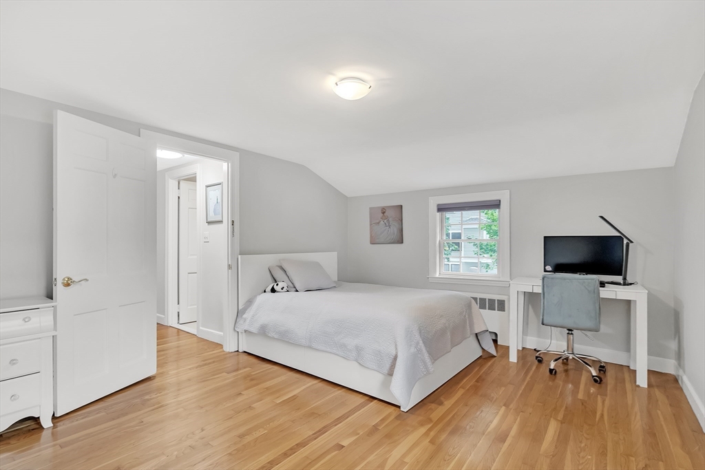 2270 Massachusetts Avenue Lexington, MA 02421 - Photo 19 of 34 a bedroom with a bed and a flat screen tv