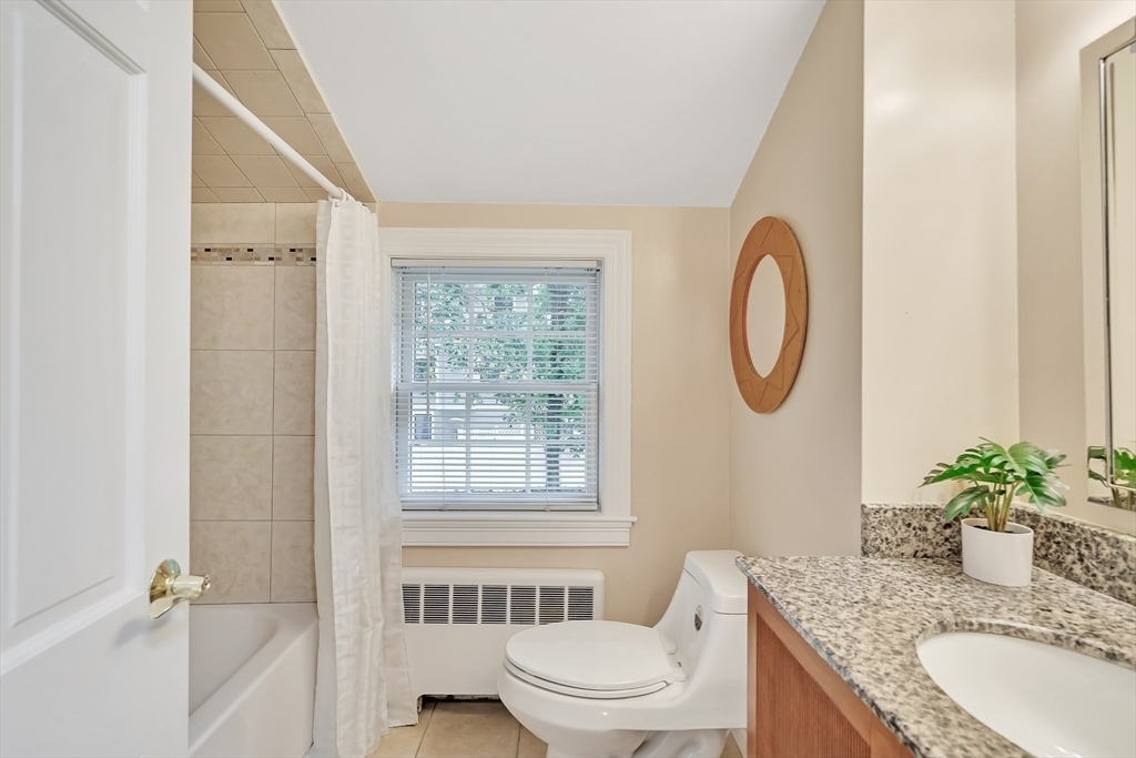 2270 Massachusetts Avenue Lexington, MA 02421 - Photo 23 of 34 a bathroom with a granite countertop sink a toilet and a mirror