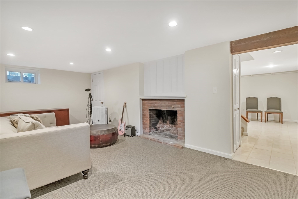 2270 Massachusetts Avenue Lexington, MA 02421 - Photo 29 of 34 a living room with furniture and a fireplace
