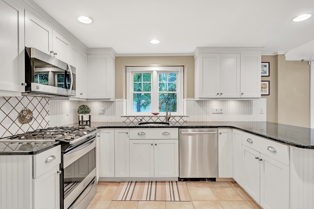 2270 Massachusetts Avenue Lexington, MA 02421 - Photo 6 of 34 a kitchen with granite countertop white cabinets stainless steel appliances a sink and a window