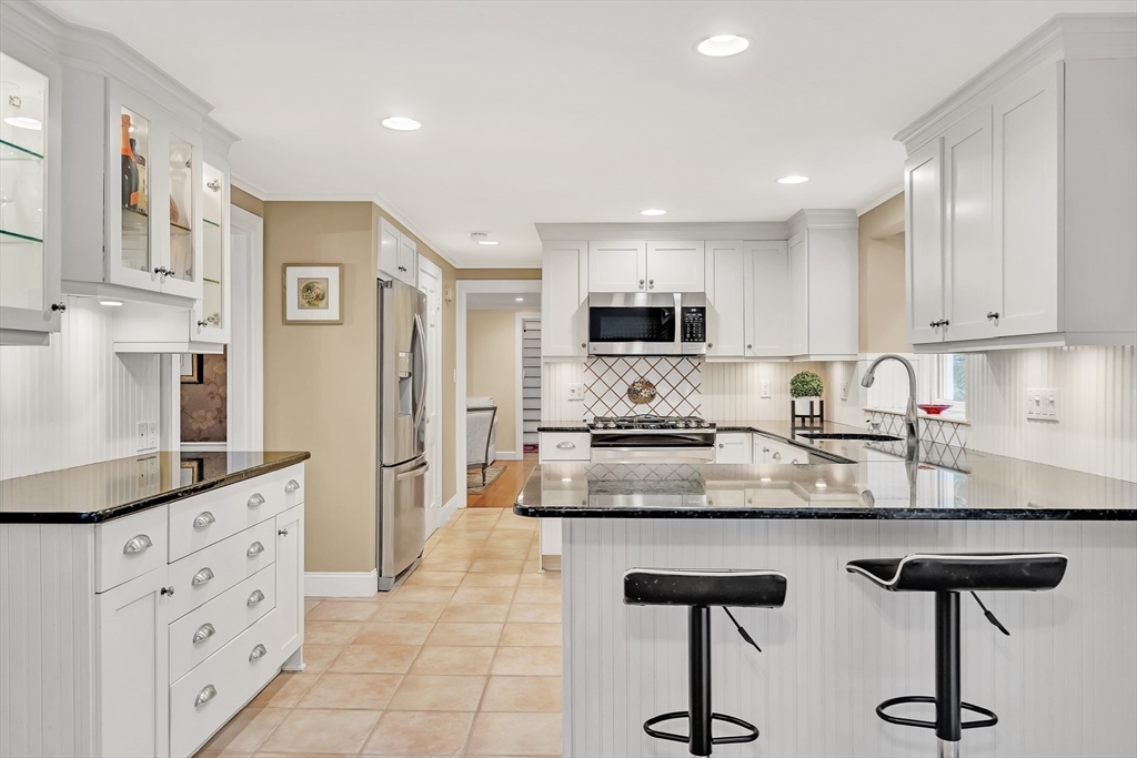 2270 Massachusetts Avenue Lexington, MA 02421 - Photo 7 of 34 a kitchen with granite countertop white cabinets and appliances