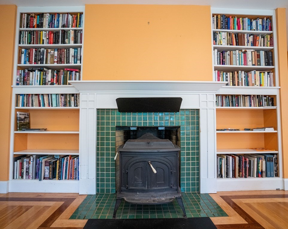 16 Long Hill Road Leverett, MA 01054 - Photo 13 of 38 a living room with a bookshelf and a fireplace