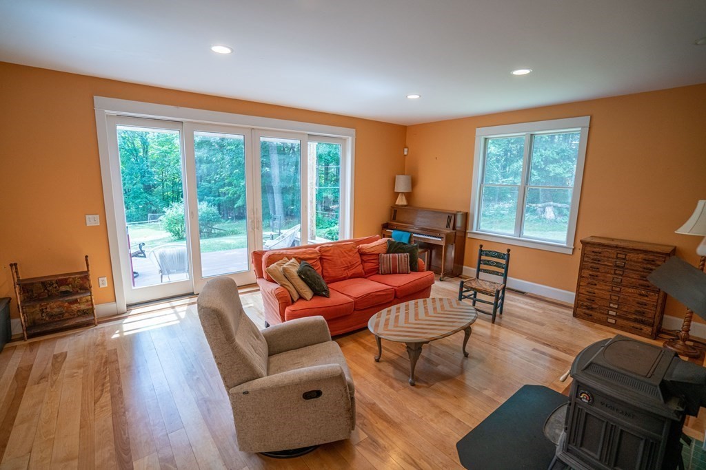 16 Long Hill Road Leverett, MA 01054 - Photo 14 of 38 a living room with furniture a large window and wooden floor