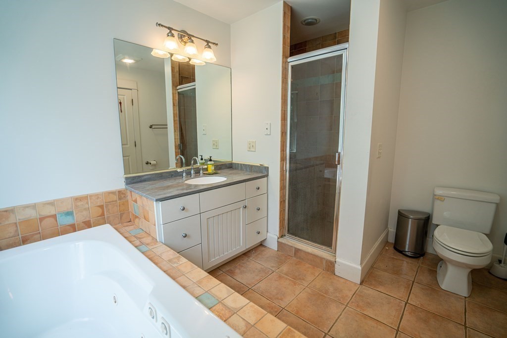 16 Long Hill Road Leverett, MA 01054 - Photo 23 of 38 a spacious bathroom with a granite countertop sink toilet and shower