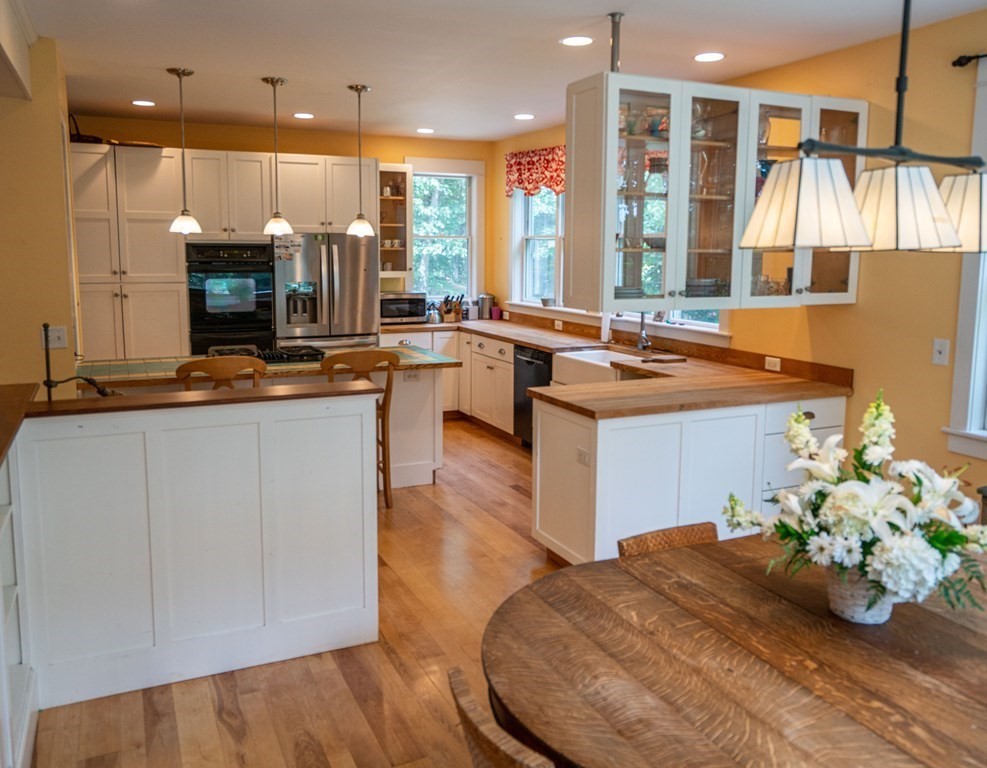 16 Long Hill Road Leverett, MA 01054 - Photo 5 of 38 a kitchen with stainless steel appliances granite countertop a stove a sink and a microwave