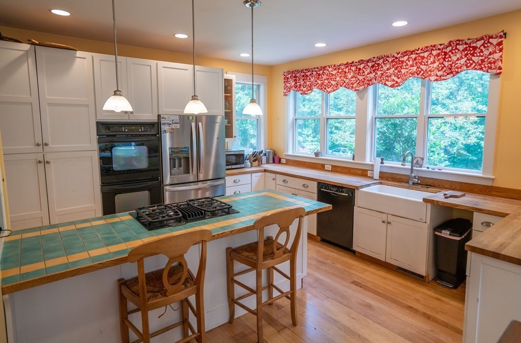 16 Long Hill Road Leverett, MA 01054 - Photo 8 of 38 a kitchen with a table chairs sink and wooden floor