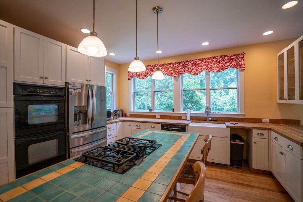 16 Long Hill Road Leverett, MA 01054 - Photo 9 of 38 a kitchen with stainless steel appliances granite countertop a stove a sink and a refrigerator
