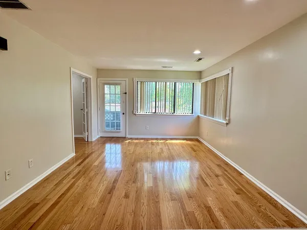 wooden floor in an empty room with a window