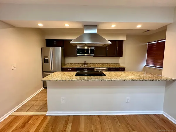 a kitchen with a stove and a refrigerator