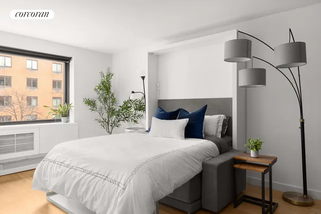 a large bed sitting in a bedroom next to a window