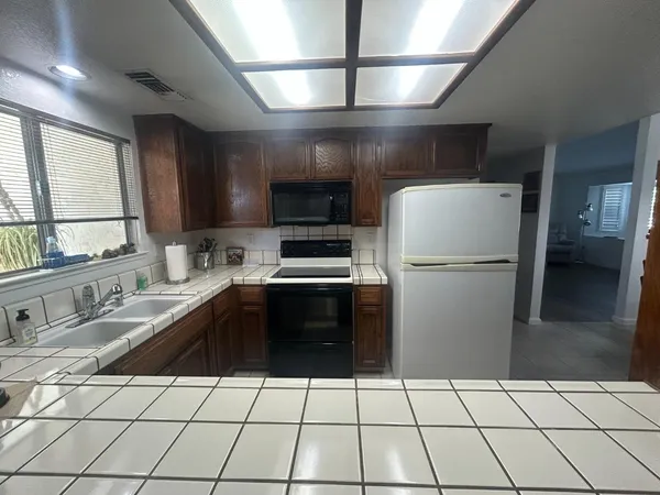 a stove top oven sitting inside of a kitchen