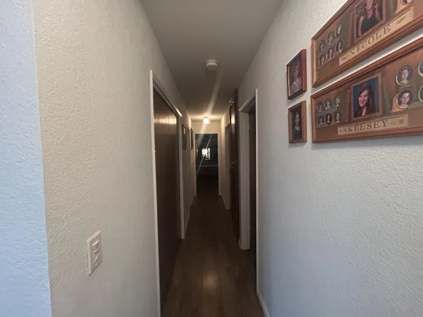 an empty room with a ceiling fan and window