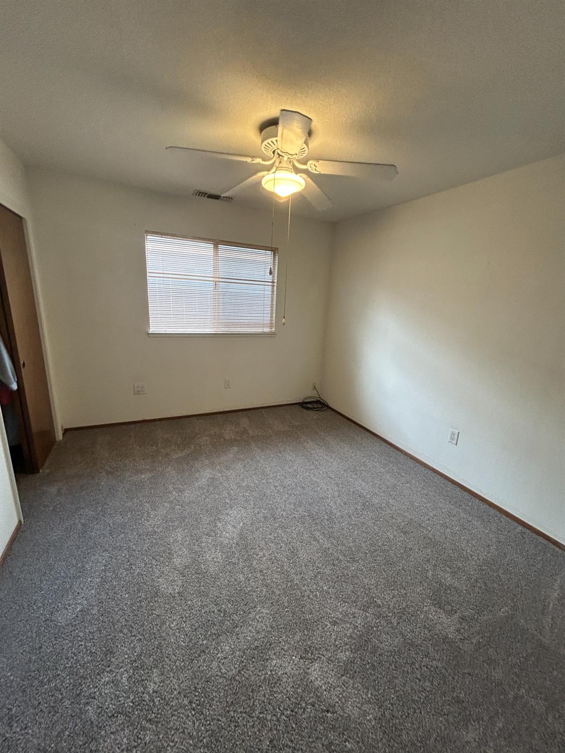 4529 Fallbrook Place Salida, CA 95368 - Photo 14 of 26 an empty room with a ceiling fan and window