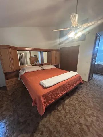 a bedroom with a bed and a chandelier