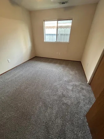a view of an empty room with a sink and a fireplace