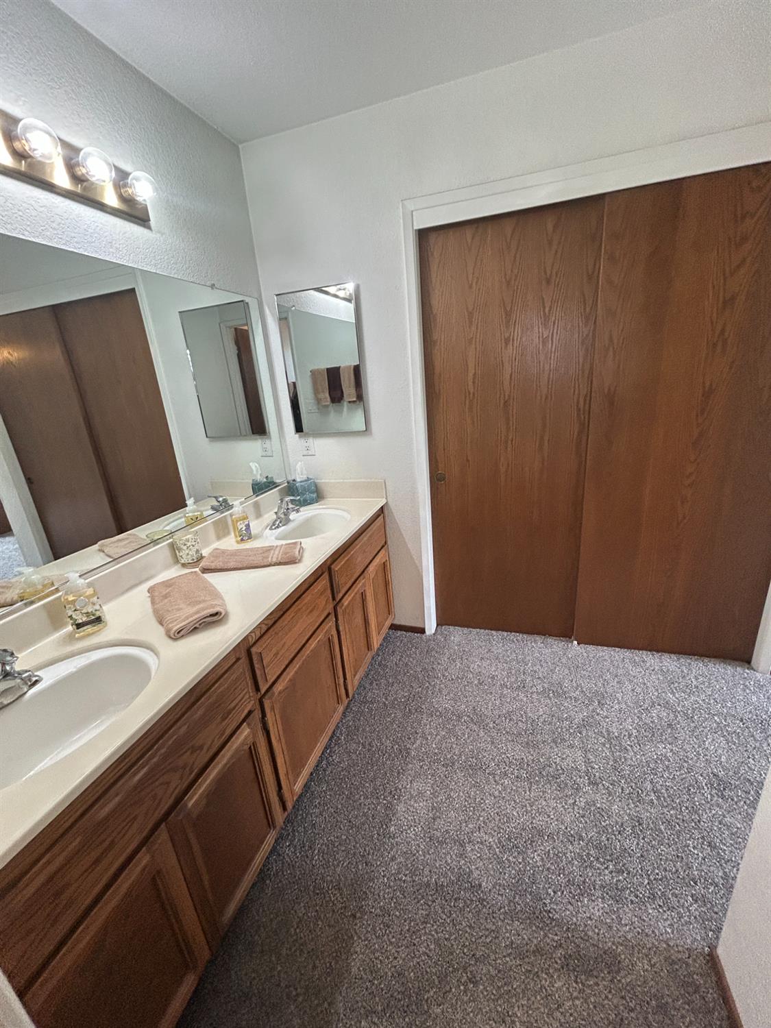 4529 Fallbrook Place Salida, CA 95368 - Photo 20 of 26 a spacious bathroom with a double vanity sink and a mirror