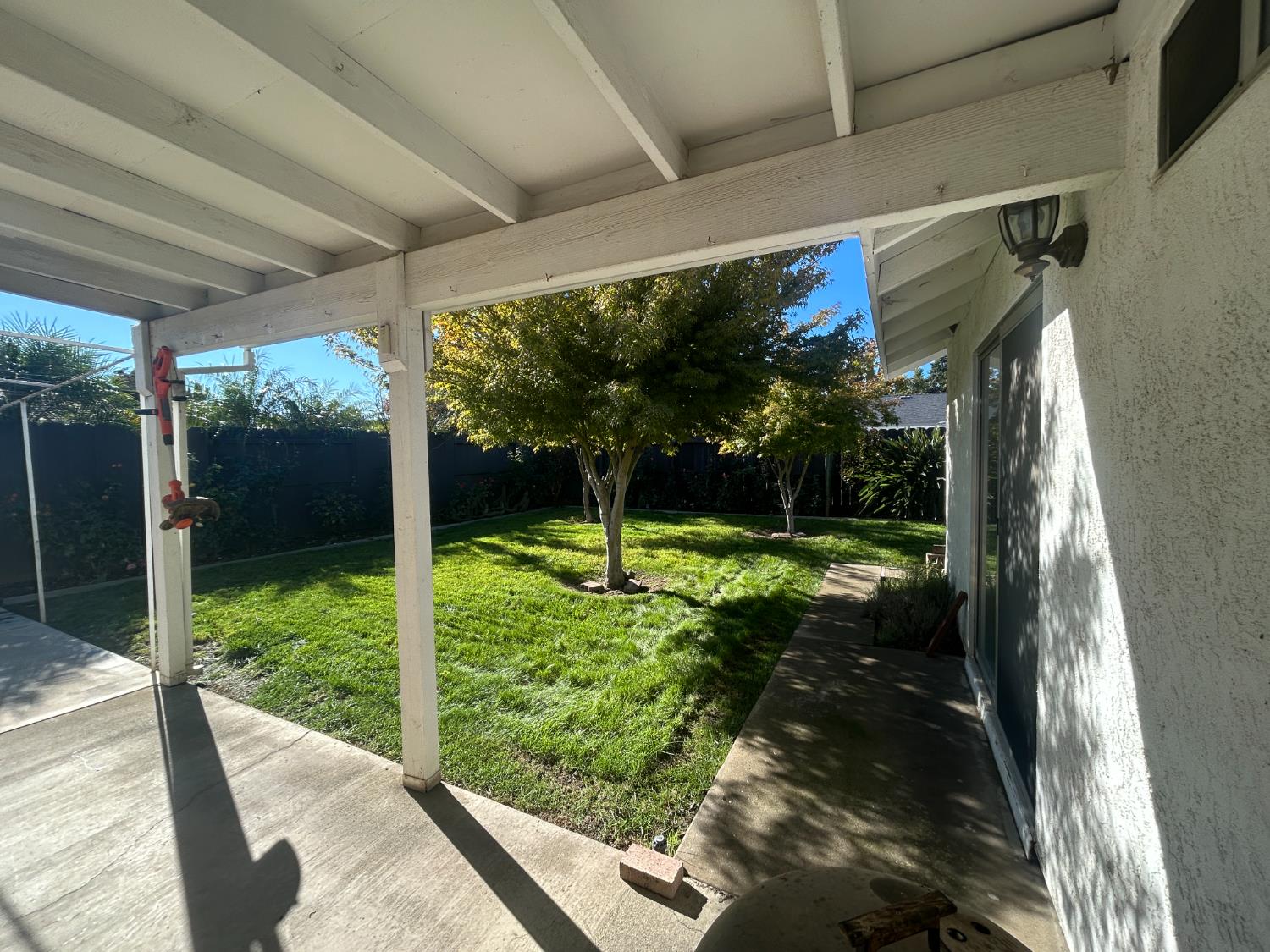 4529 Fallbrook Place Salida, CA 95368 - Photo 23 of 26 a view of a porch with a big yard potted plants and floor to ceiling window
