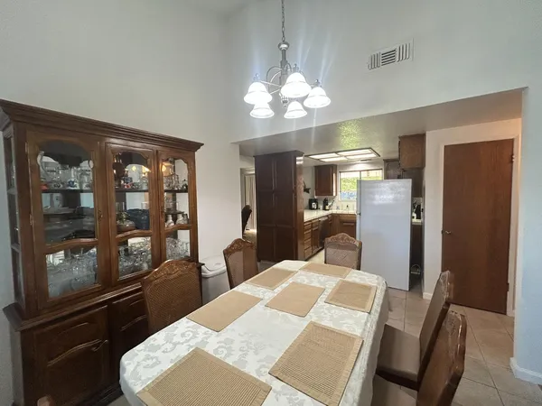 a view of a dining room with furniture and chandelier