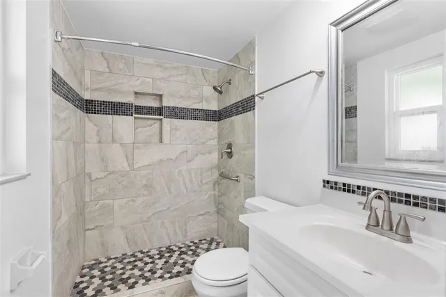 a bathroom with a sink toilet and shower