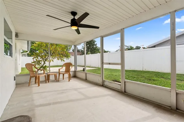 a view of a porch with furniture and a yard