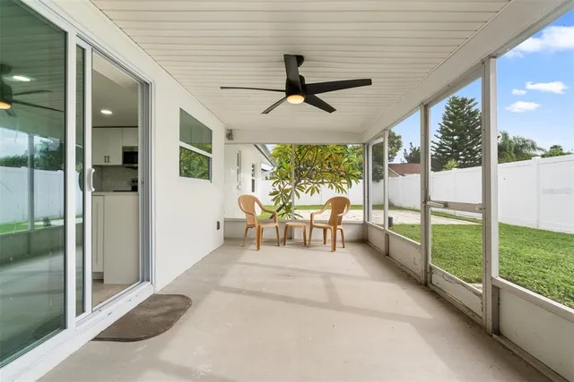 a view of a porch with furniture and garden