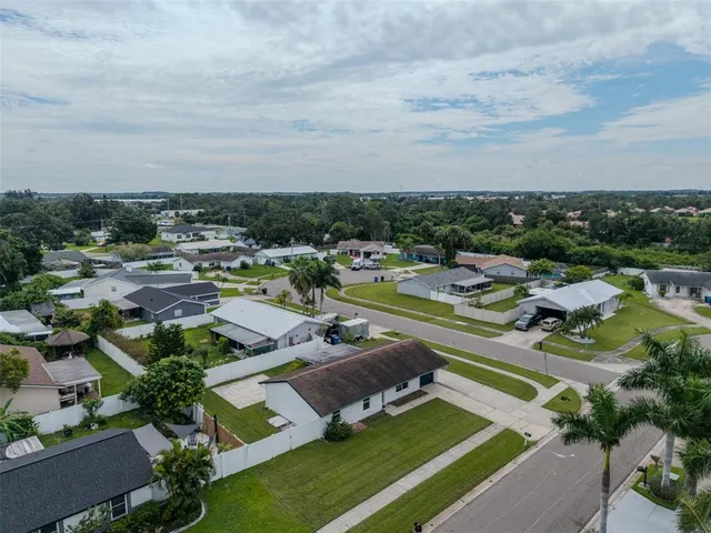 an aerial view of a house with swimming pool outdoor seating and yard