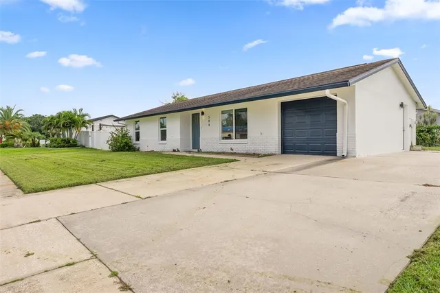 a view of a house with a yard and garage