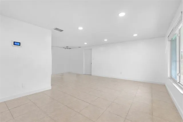 an empty room with a empty space and windows